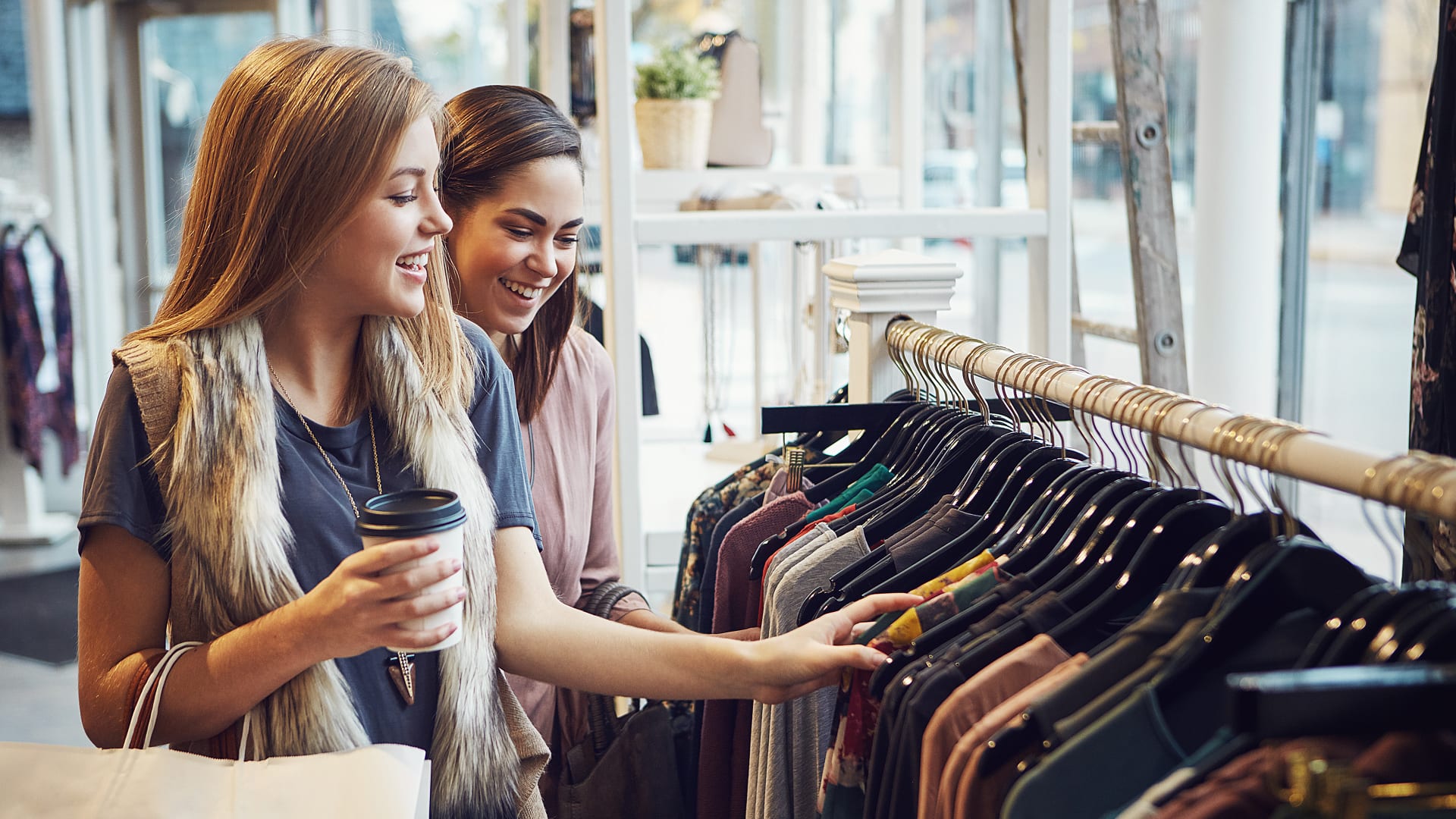 Two women smiling while shopping