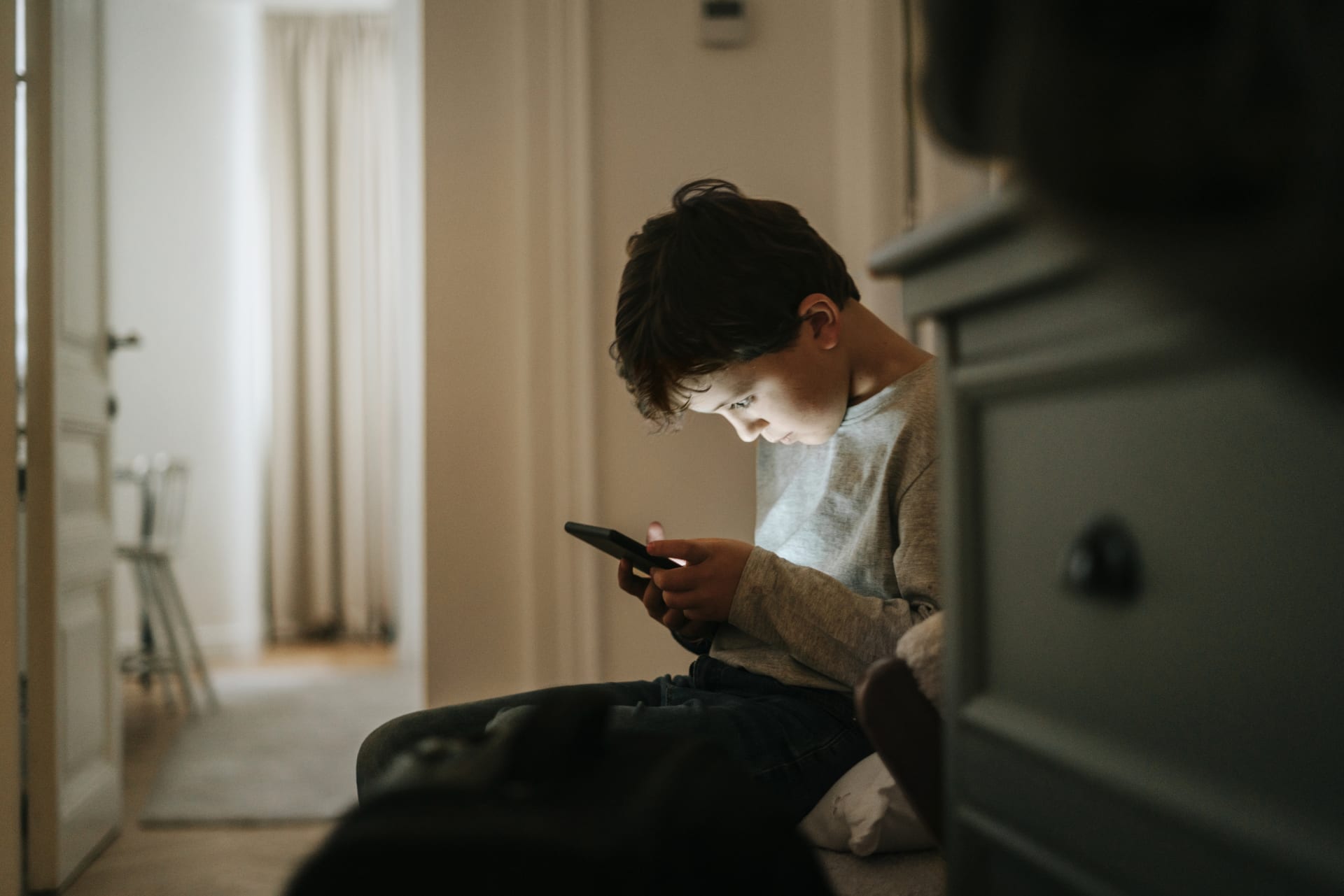 Young boy looking at phone